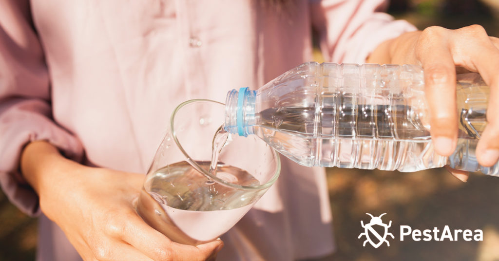 Girl-pouring-water from a bottle